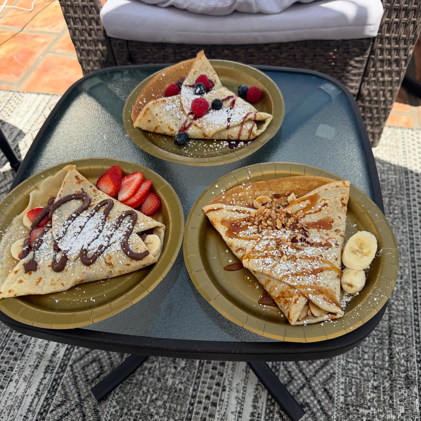 Jannet Catering team serving crepes at an elegant outdoor reception.
